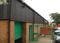 Front left elevation of Industrial building previously coated with a Plastisol paint system. Weston Painting Contractors of Cardiff completely degreased all sub-straights prior to the application of Rust-Oleum Mathys Peganox to obtain maximum substrate adhesion.