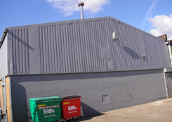 Newly painted rear gabel end of industrial unit. All the external steel cladding was finished with Crown Fast Drying water based Cladding Paint System and all brickwork below was painted with Crown oil based Pliolite to match the cladding. All preparation and painting works were carried out by Weston Painting Contractors of Cardiff South Wales.