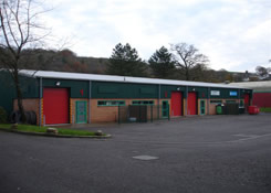 Newly completed paint system - front left elevation of Industrial building which was previously coated with a Plastisol paint system. Weston Painting Contractors of Cardiff prepared and re-painted the complete Industrial unit by way of airless spraying and brushing. The building was finished with a Rust-Oleum Mathys Peganox - Moss Green which will provide a high build, anti corrosive membrane that has a high resistance to water, salt spray, acid and aggressive environments making it virtually unaffected over time, whilst also providing flexibility, strong adhesion and complete water resistance.